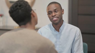 The Rear View, African Man Talking to African Woman on Sofa