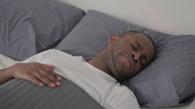 The Young African Man Laying in Bed Unable to Sleep