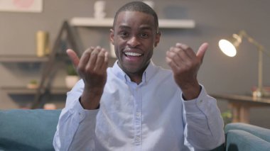 The Portrait of Young African Man Pointing at the Camera and Inviting