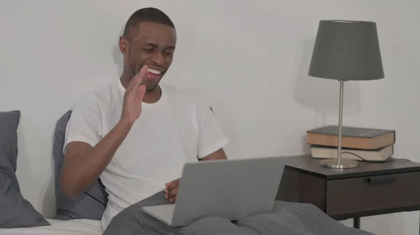 Young African Man Doing Video Call Laptop Bed — Stock Fotó