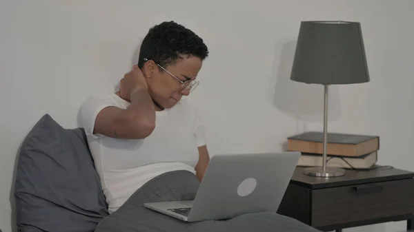 Young African Woman Having Neck Pain While Using Laptop Bed —  Fotos de Stock
