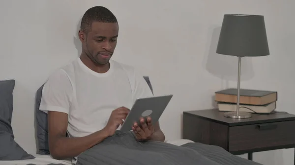 Young Man Using Tablet While Sitting Bed — 스톡 사진