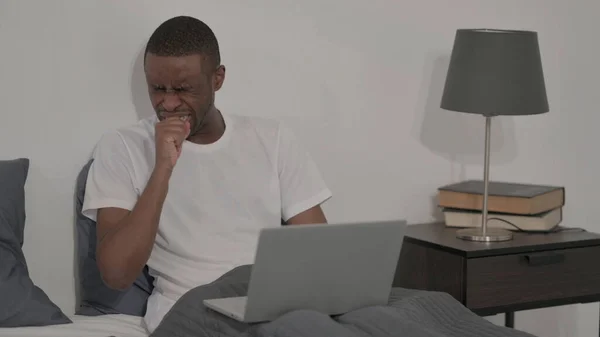 Young African Man Coughing While Working Laptop Bed — 스톡 사진