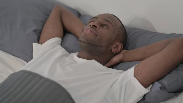 Young African Man Laying Bed Awake Thinking — Fotografia de Stock