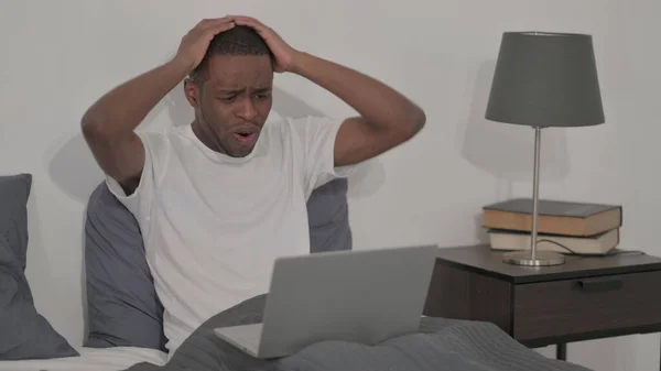 Young African Man Reacting Loss Laptop Bed — Zdjęcie stockowe