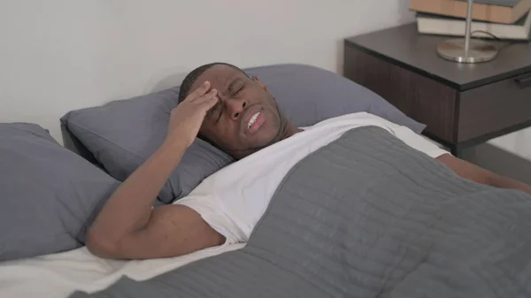 Young African Man Having Headache While Sleeping Bed — Zdjęcie stockowe