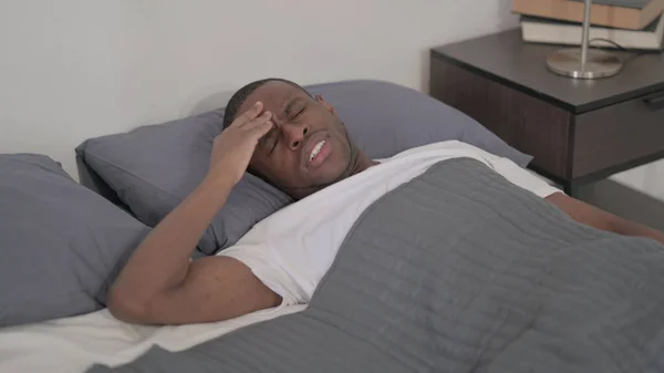 Young African Man Having Headache While Sleeping Bed — Stok fotoğraf