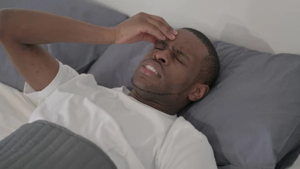 Young African Man Having Headache While Sleeping Bed Close — Fotografia de Stock