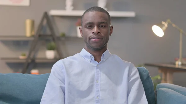 Portrait Young African Man Looking Camera Sofa —  Fotos de Stock