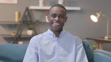 The Portrait of Young African Man Smiling at the Camera, Sofa
