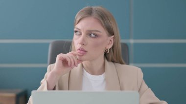 Ofiste Dizüstü bilgisayar üzerinde çalışırken Düşünen Genç İş kadınının Kapanışı