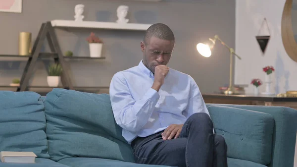Young African Man Coughing While Sitting Sofa —  Fotos de Stock