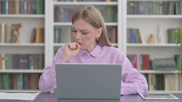 Sick Young Woman Coughing Working on Laptop