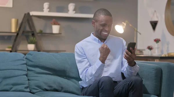 Successful Young African Man Celebrating Smartphone —  Fotos de Stock