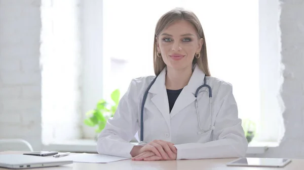 Female Doctor Shaking Head in Acceptance in clinic
