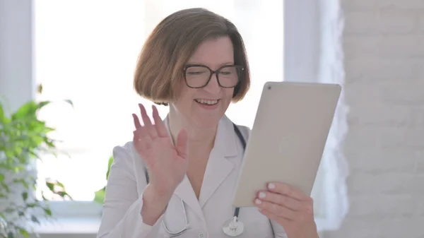 Portrait of Video Call on Tablet by Female Doctor in Office