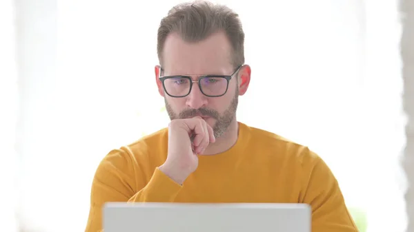 Middle Aged Man Thinking While Using Laptop — Stok Foto