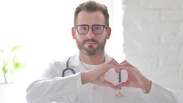 Middle Aged Doctor showing Heart Shape by Hands