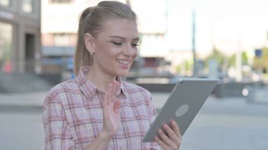 Video Call on Tablet by Casual Woman Outdoor