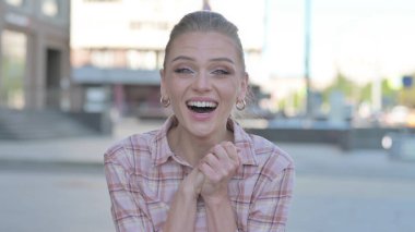 Portrait of Excited Casual Woman Celebrating Success Outdoor