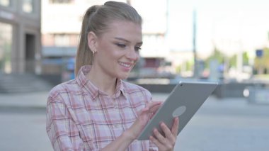 Casual Woman using Digital Tablet Outdoor