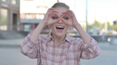 Casual Woman Looking Around with Handmade Binocular Outdoor