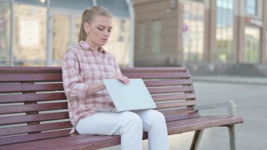 Casual Woman Leaving Bench after Closing Laptop