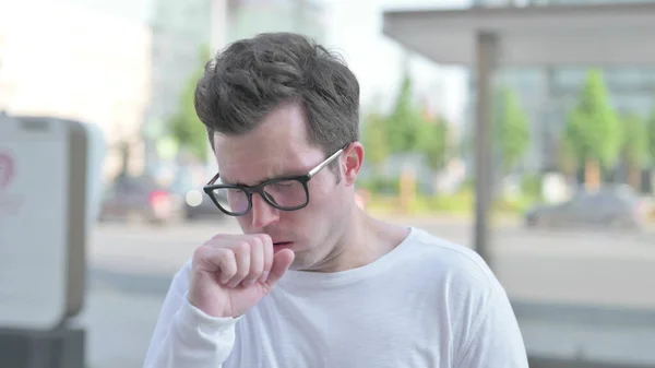 Casual Man Coughing while Standing Outdoor