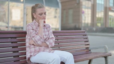 Tired Casual Woman Sleeping while Sitting Outdoor on Bench