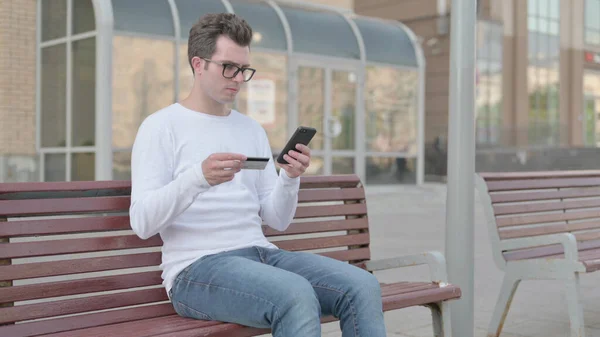 Excited Casual Man Shopping Online Smartphone While Sitting Outdoor Bench — Foto de Stock