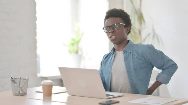 African Man Having Back Pain While Using Laptop Office — Stockfoto