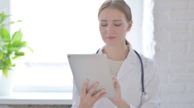 Female Doctor using Tablet for Work