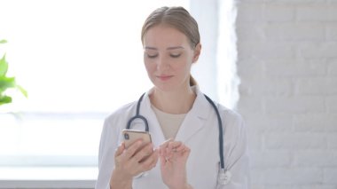 Female Doctor using Smartphone for Browsing Internet