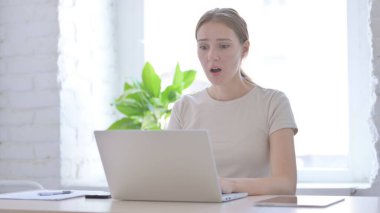 Young Woman Reacting to Loss While Working in Office