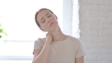 Young Woman in Pain Massaging Her Neck