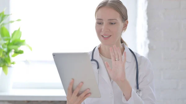 Online Video Call on Tablet by Female Doctor