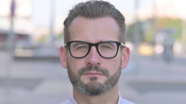 Close up of Adult Man Face Looking at the Camera Outdoor