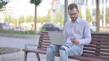 Adult Man making Online Payment Failure on Laptop in Office
