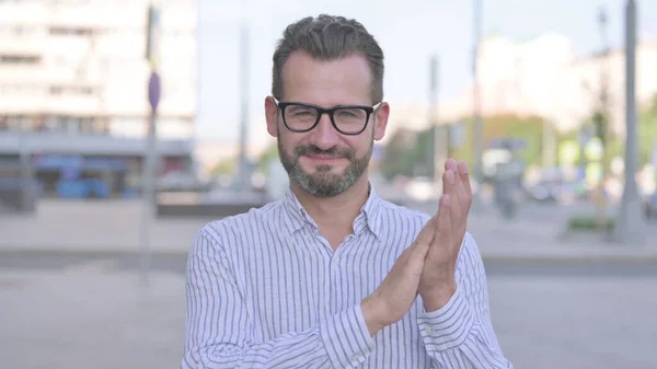 Adult Man Clapping in Appreciation Outdoor