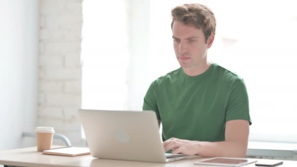 Casual Young Man Having Back Pain While Using Laptop — Stock Video
