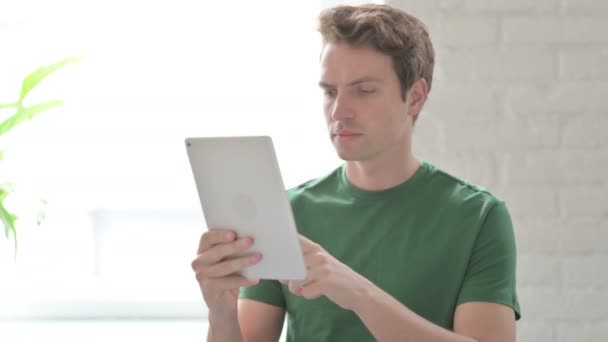 Casual Young Man Using Digital Tablet Browsing Internet — Stock Video