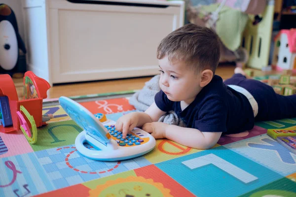 好奇的小孩在玩他的玩具电脑 — 图库照片