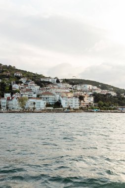 white and modern turkish houses near seaside on princess islands in turkey  clipart