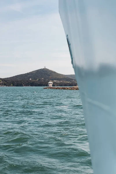 Drapeau turc sur la jetée près de la mer sur le bosphore avec bateau de ferry flou de premier plan — Photo de stock