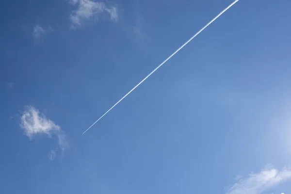 Airplane leaves vapor trails in the sky