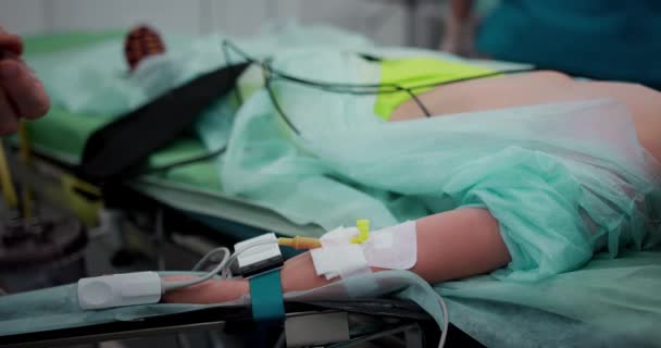 De verpleegkundige maakt een intraveneuze infusie ter voorbereiding van de operatie. Close-up van een hand met een katheter. — Stockvideo