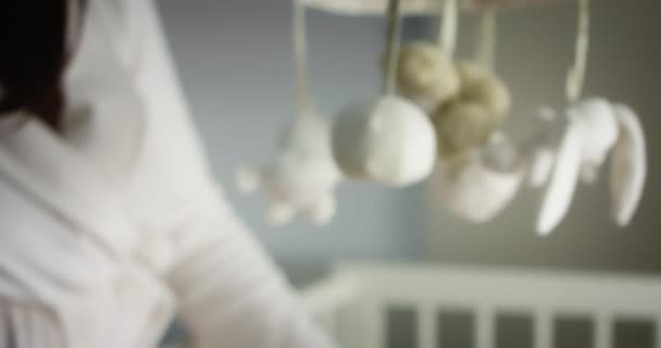 Baby mobile with different animals hanging over the child crib of a newborn — Vídeo de Stock