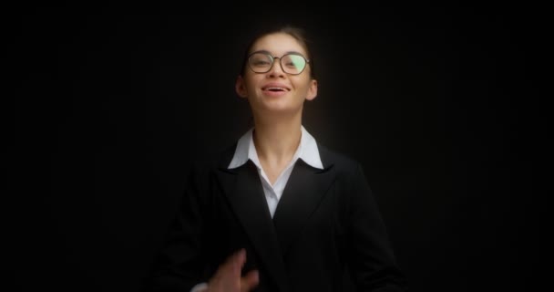 Businesswoman claps her hands, applauds standing on a black background — Stock Video