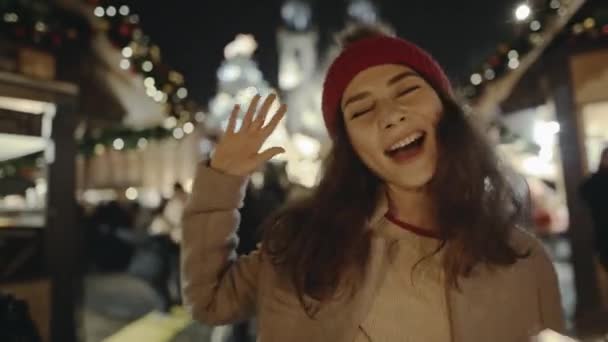 Selfie time, girl blogger is making video and photo for her social page at the street fair on the central Square of Prague. Gorgeous Asian smiling and burning bright sparklers on New Years Eve. — Stock Footage Selfie time, girl blogger is making video and photo for her social page at the street fair on the central Square of Prague. Gorgeous Asian smiling and burning bright sparklers on New Years Eve. Video Clip