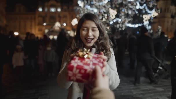 Portrait of beautiful girl receiving present from cameraman. Young woman really happy and touched, approaching to hug friend outside in european town. — Stock Footage Portrait of beautiful girl receiving present from cameraman. Young woman really happy and touched, approaching to hug friend outside in european town. Stock Footage